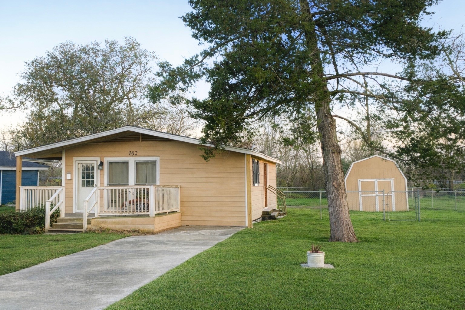 102 Magnolia Street Lake Jackson, TX 77566 - Photo 1 of 8 a view of a house with a yard and large tree