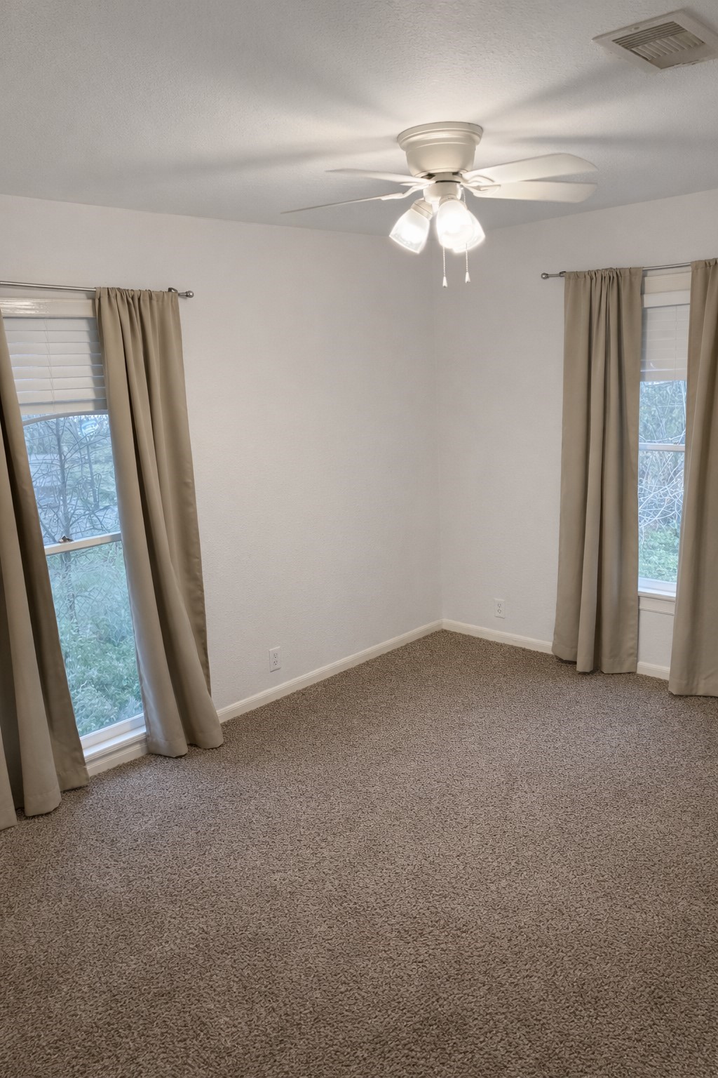 102 Magnolia Street Lake Jackson, TX 77566 - Photo 8 of 8 an empty room with a chandelier fan and window