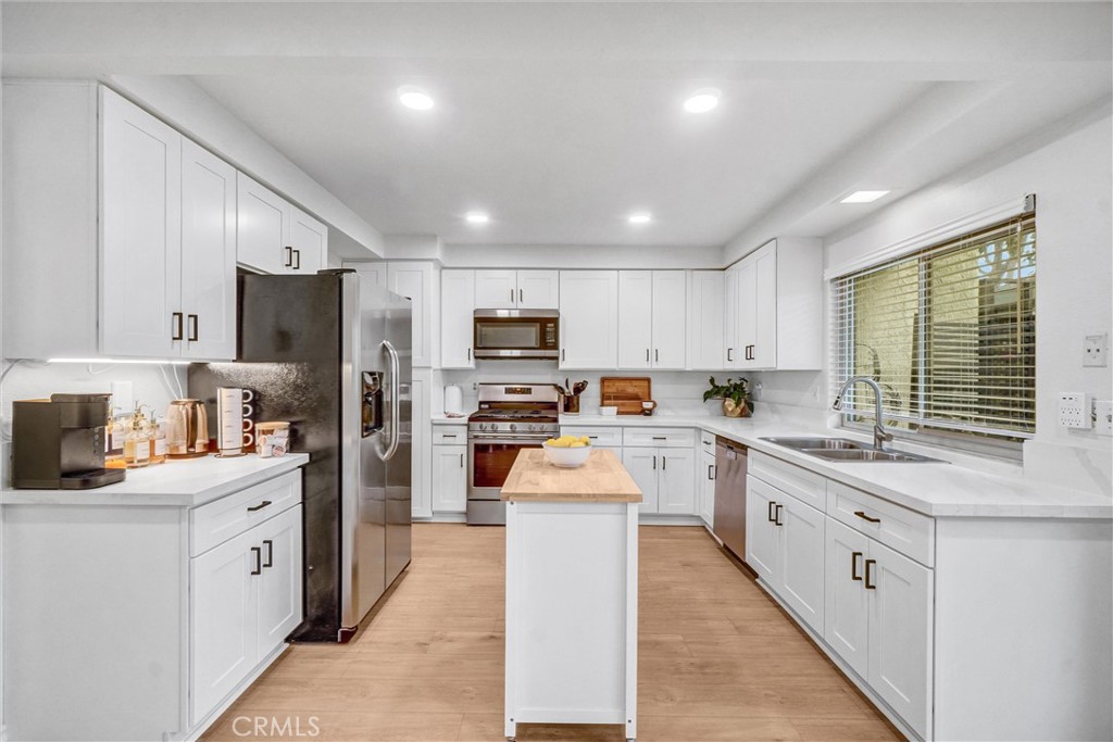 1514 Via Del Rio Corona, CA 92882 - Photo 12 of 41 a kitchen with white cabinets and stainless steel appliances