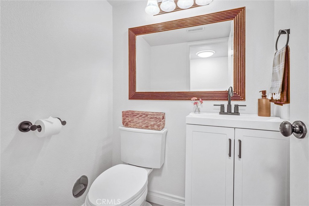 1514 Via Del Rio Corona, CA 92882 - Photo 25 of 41 a bathroom with a toilet sink vanity and mirror
