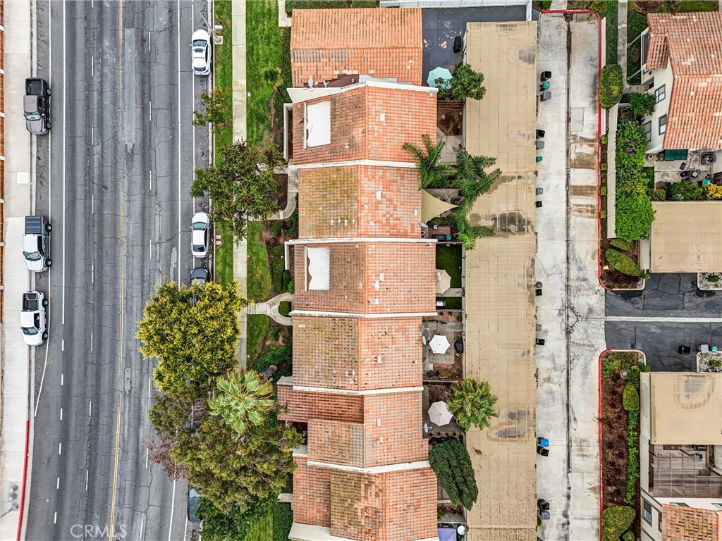 1514 Via Del Rio Corona, CA 92882 - Photo 30 of 41 an aerial view of a residential apartment building with a yard and table and chairs