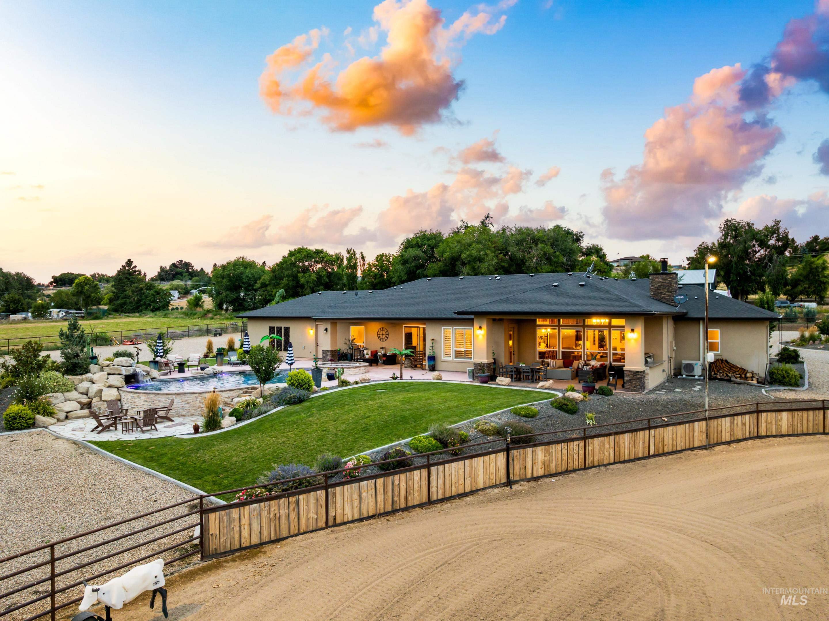9819 Foothill Road Middleton, ID 83644 - Photo 39 of 49 Back of house at dusk with an outdoor living space, a patio area, and stucco siding