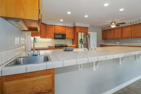 a kitchen with stainless steel appliances a sink stove and cabinets