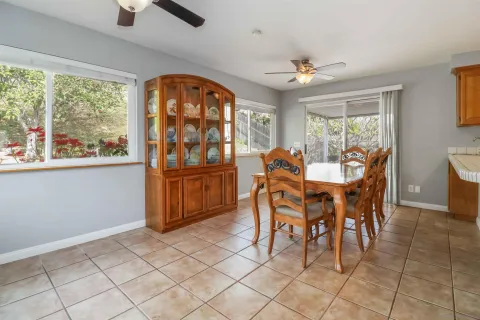 a dining room with furniture a chandelier and window