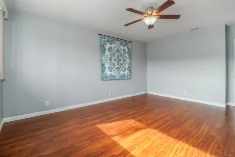 wooden floor in an empty room with a window