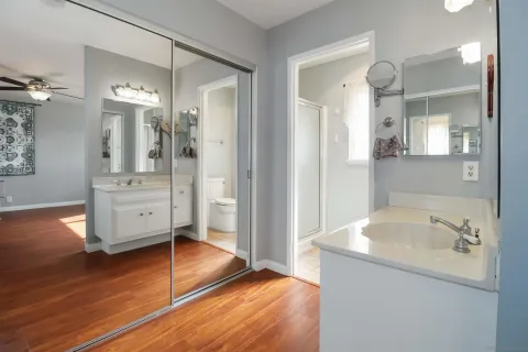 a bathroom with a tub sink and mirror