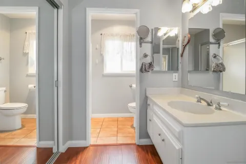 a spacious bathroom with a bathtub sink and toilet