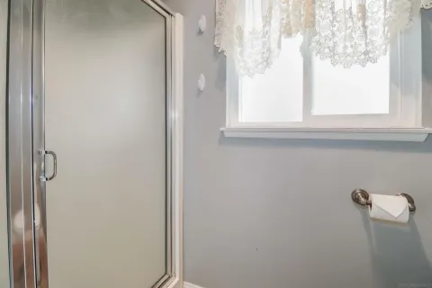 a bathroom with a window and a shower