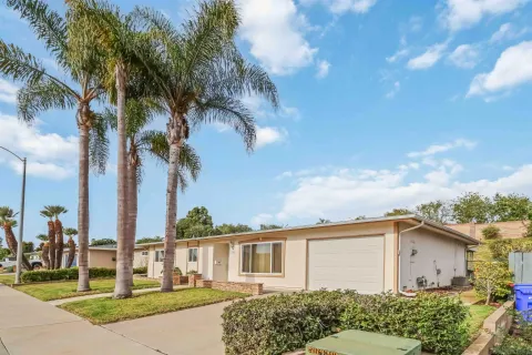 a view of a house with a backyard