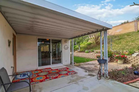 a outdoor space with the couches and dining table with garden view