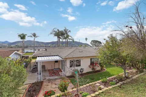 an aerial view of a house with a yard table and chairs