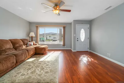 a living room with furniture and a large window