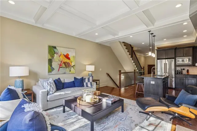 a living room with furniture kitchen view and a table
