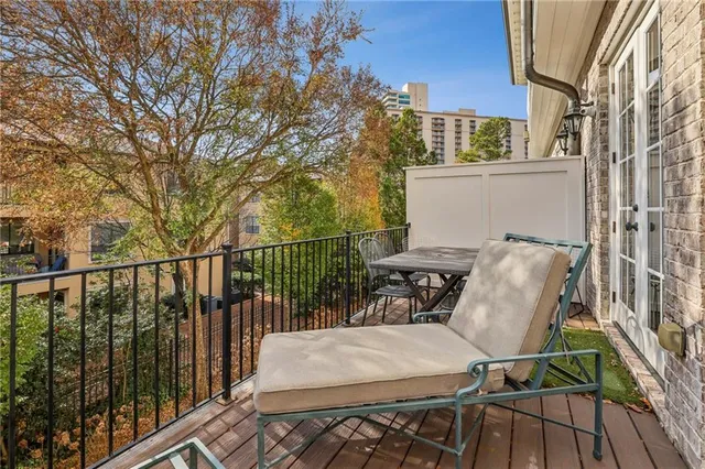 a view of a chairs and table in the balcony