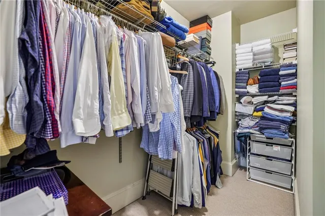 a view of walk in closet with clothes