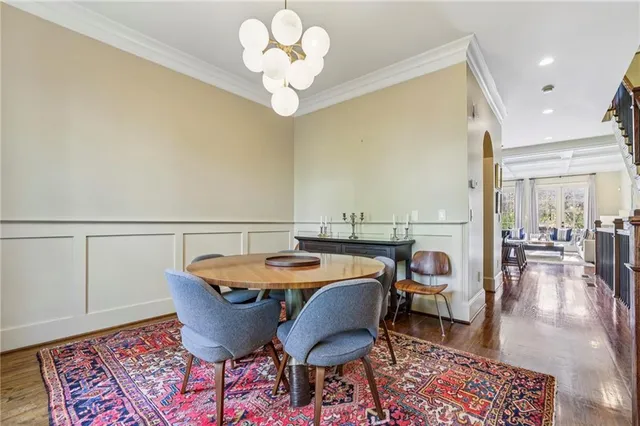 a view of a dining room with furniture wooden floor and chandelier