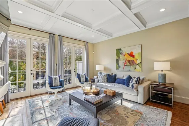 a living room with furniture and a floor to ceiling window