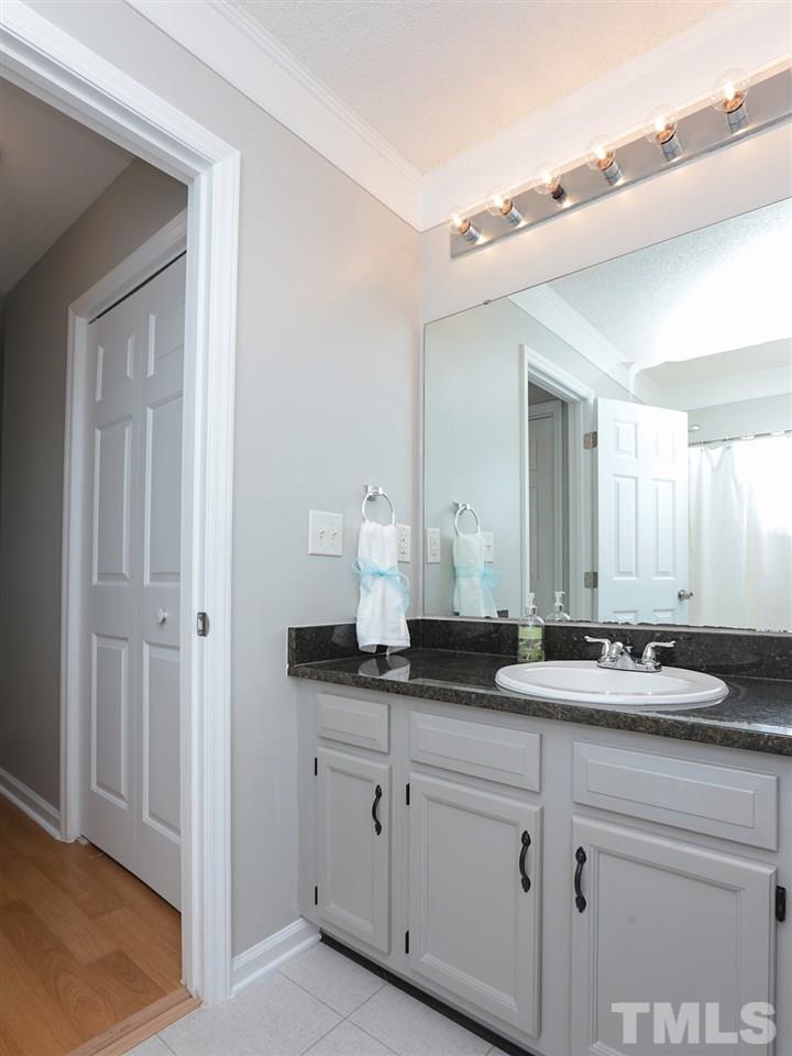 3537 East Jameson Road Raleigh, NC 27604 - Photo 14 of 17 a bathroom with a granite countertop sink and a mirror