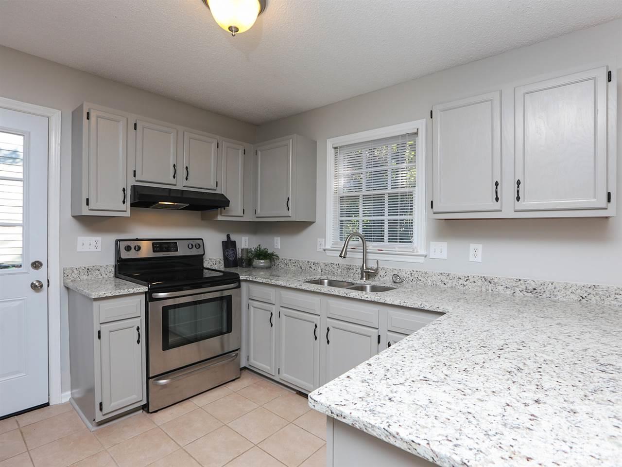 3537 East Jameson Road Raleigh, NC 27604 - Photo 3 of 17 a kitchen with granite countertop a sink stainless steel appliances and cabinets