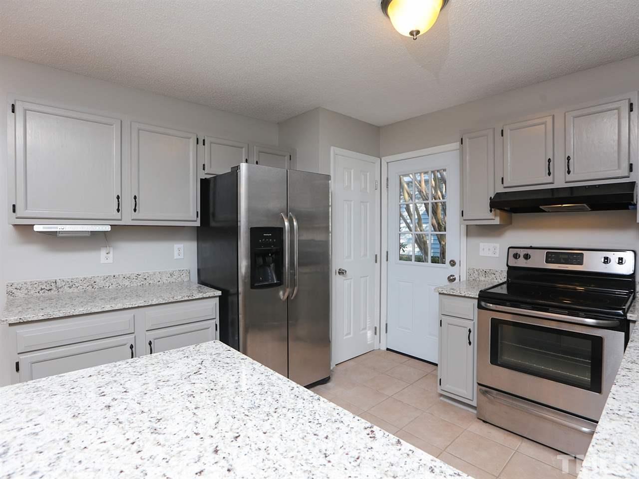 3537 East Jameson Road Raleigh, NC 27604 - Photo 5 of 17 a kitchen with a stove and a refrigerator