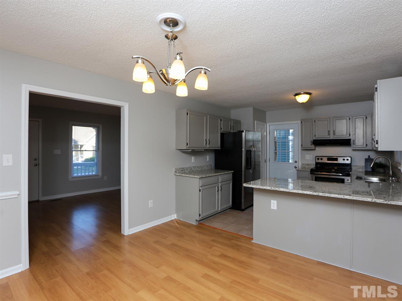 3537 East Jameson Road Raleigh, NC 27604 - Photo 6 of 17 a kitchen with stainless steel appliances a stove top oven a sink cabinets and wooden floor