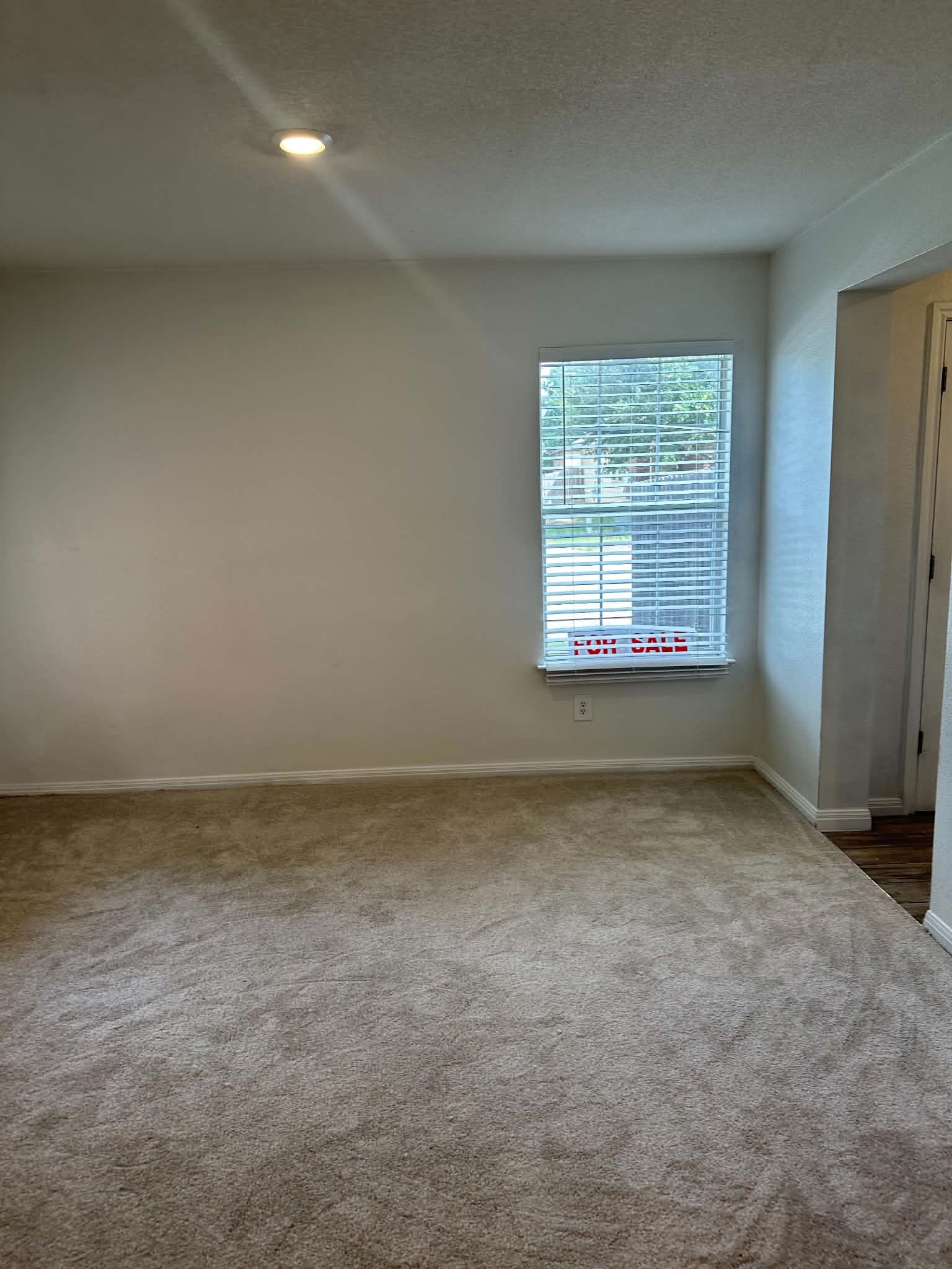18312 Crestwind Lane Elgin, TX 78621 - Photo 3 of 15 An inviting room awaits with neutral carpet and ample natural illumination from a well-placed window.