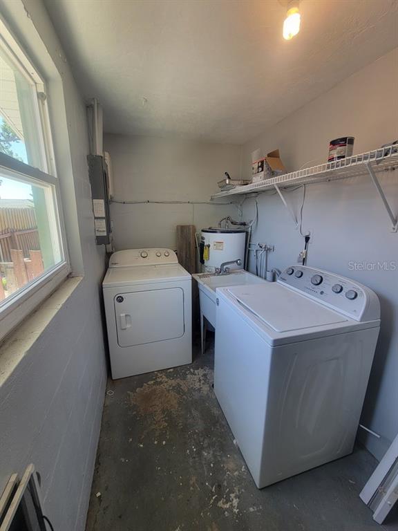 10225 Gardenia Lane Port Richey, FL 34668 - Photo 16 of 17 a utility room with dryer and washer