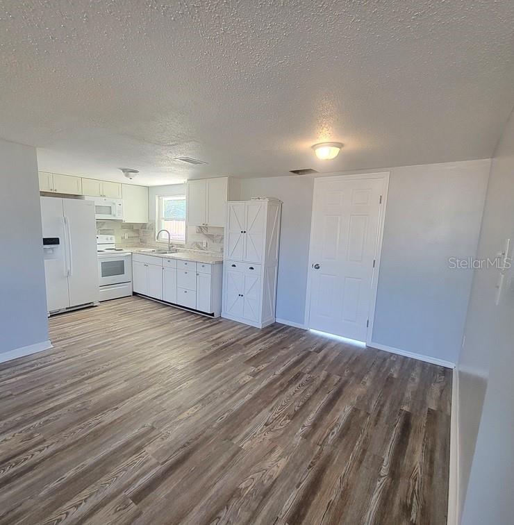 10225 Gardenia Lane Port Richey, FL 34668 - Photo 5 of 17 a view of a kitchen with wooden floor