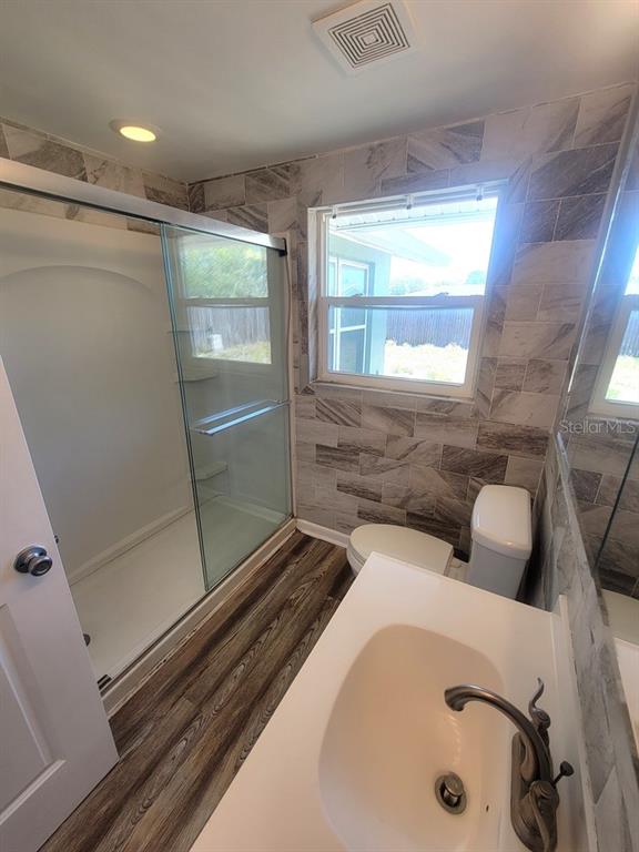 10225 Gardenia Lane Port Richey, FL 34668 - Photo 10 of 17 a bathroom with a tub and shower
