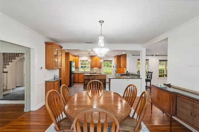 a large kitchen with kitchen island granite countertop wooden floor stainless steel appliances and cabinets