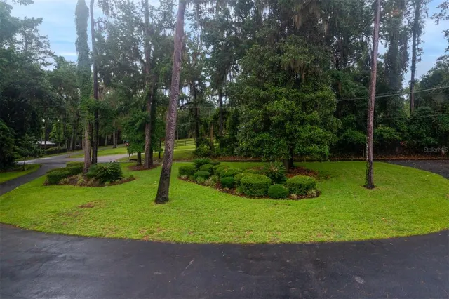 a bedroom with a large bed and a fireplace
