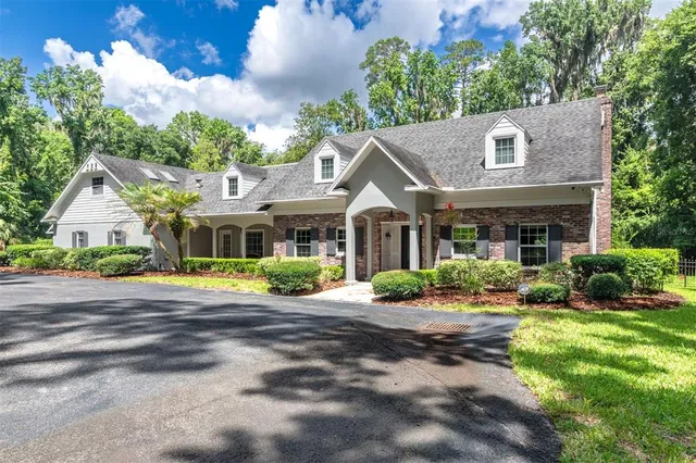 a front view of a house with a yard and trees