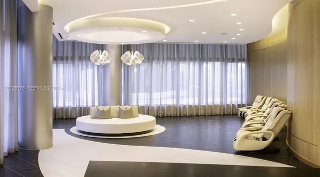 a living room with furniture and a chandelier