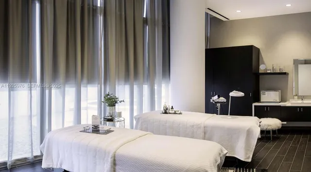 a bedroom with a double bed and a large mirror