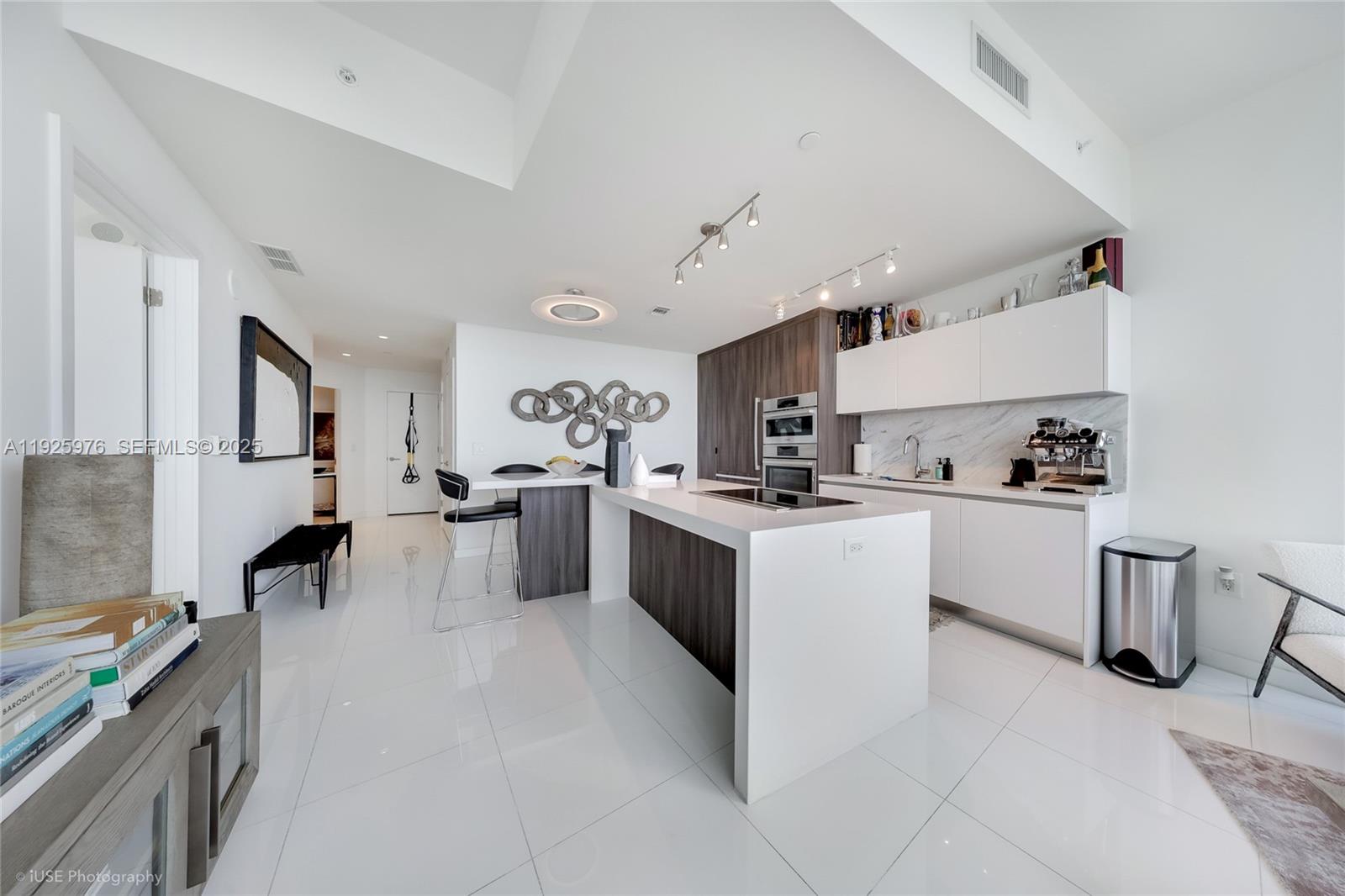 851 Northeast 1st Avenue, Unit 3810 Miami, FL 33132 - Photo 22 of 32 a kitchen with white cabinets and white appliances