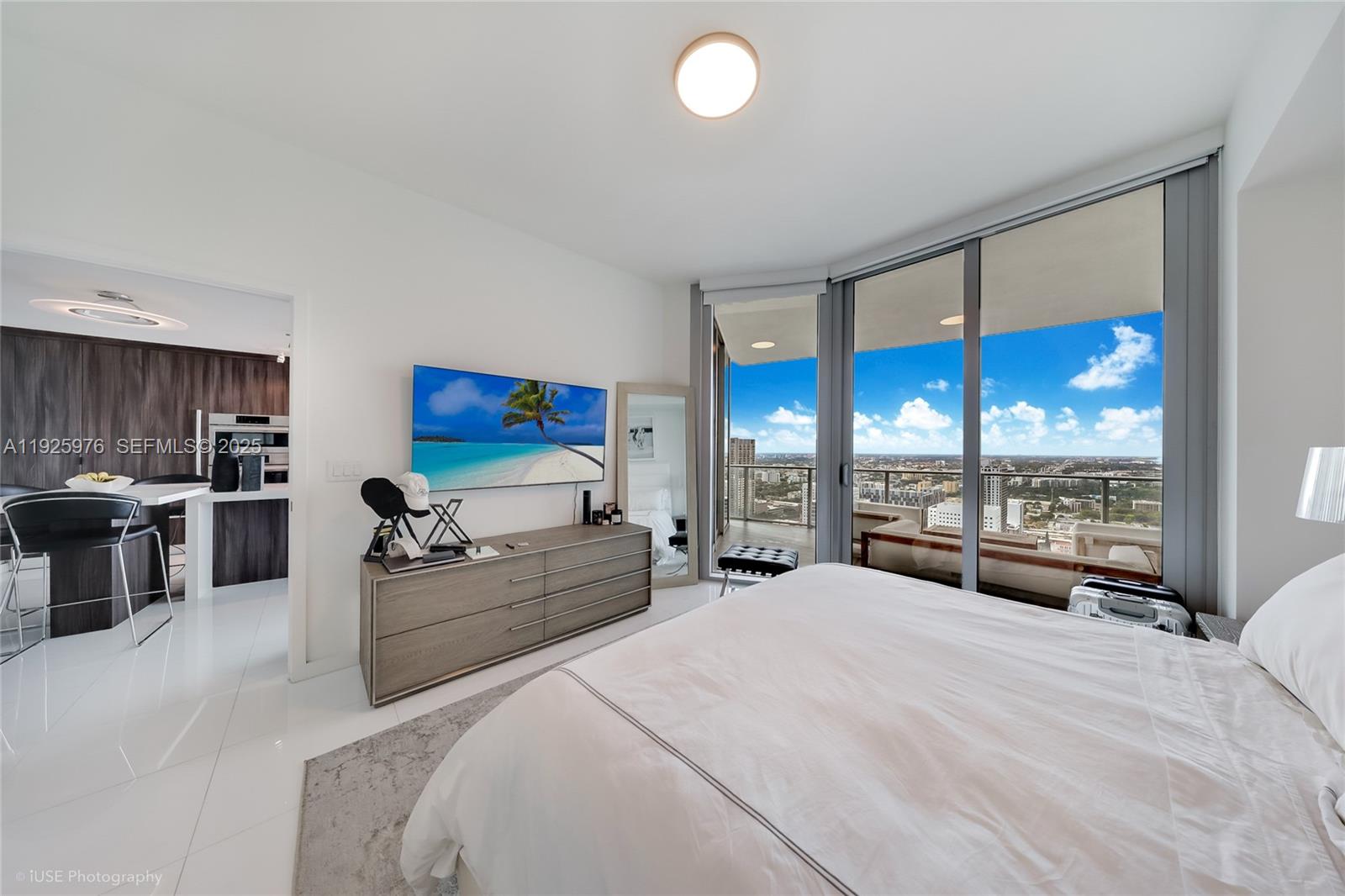 851 Northeast 1st Avenue, Unit 3810 Miami, FL 33132 - Photo 27 of 32 a large bedroom with bed and large window