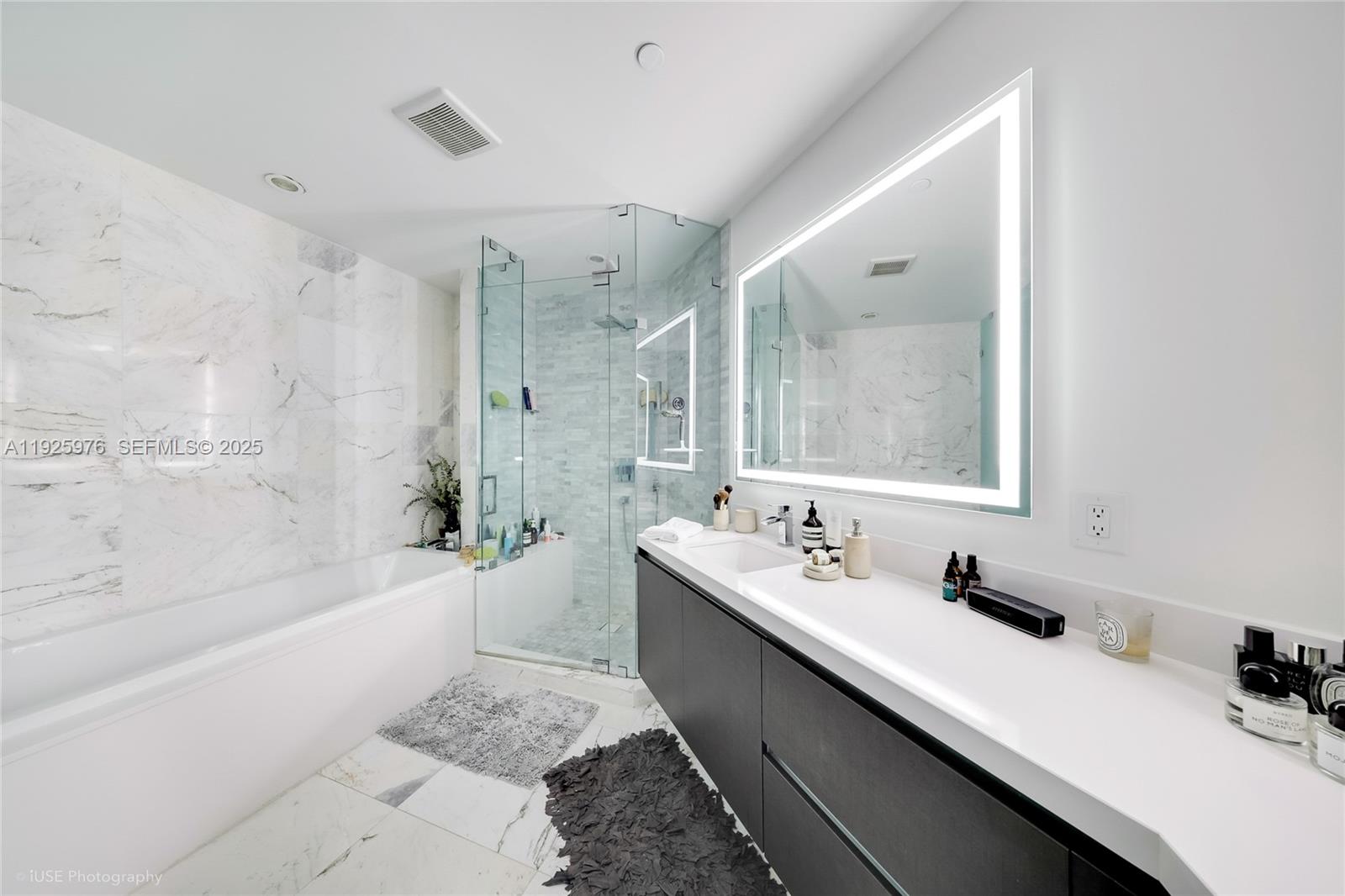 851 Northeast 1st Avenue, Unit 3810 Miami, FL 33132 - Photo 28 of 32 a bathroom with a double vanity sink mirror double and bathtub