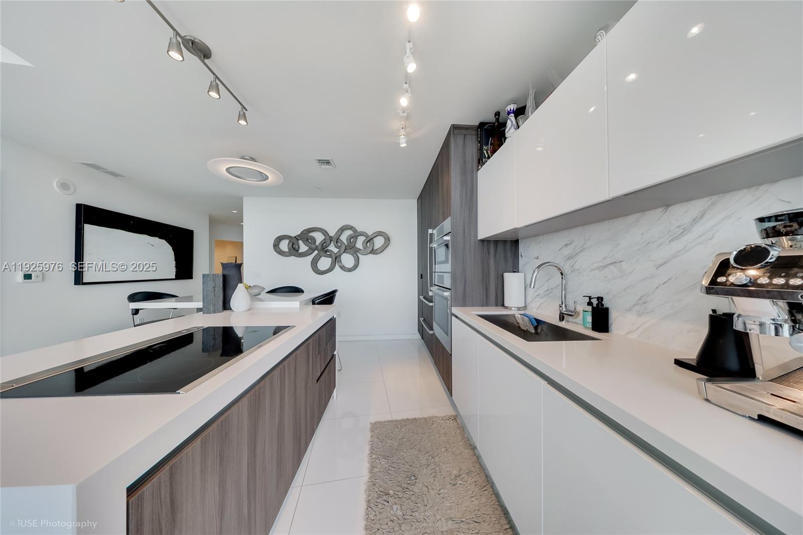 851 Northeast 1st Avenue, Unit 3810 Miami, FL 33132 - Photo 32 of 32 a kitchen with stainless steel appliances a sink stove and cabinets