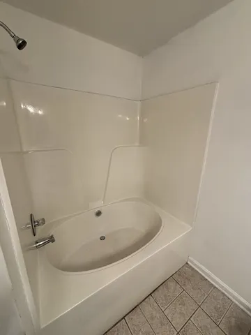 a white bath tub sitting in a bathroom