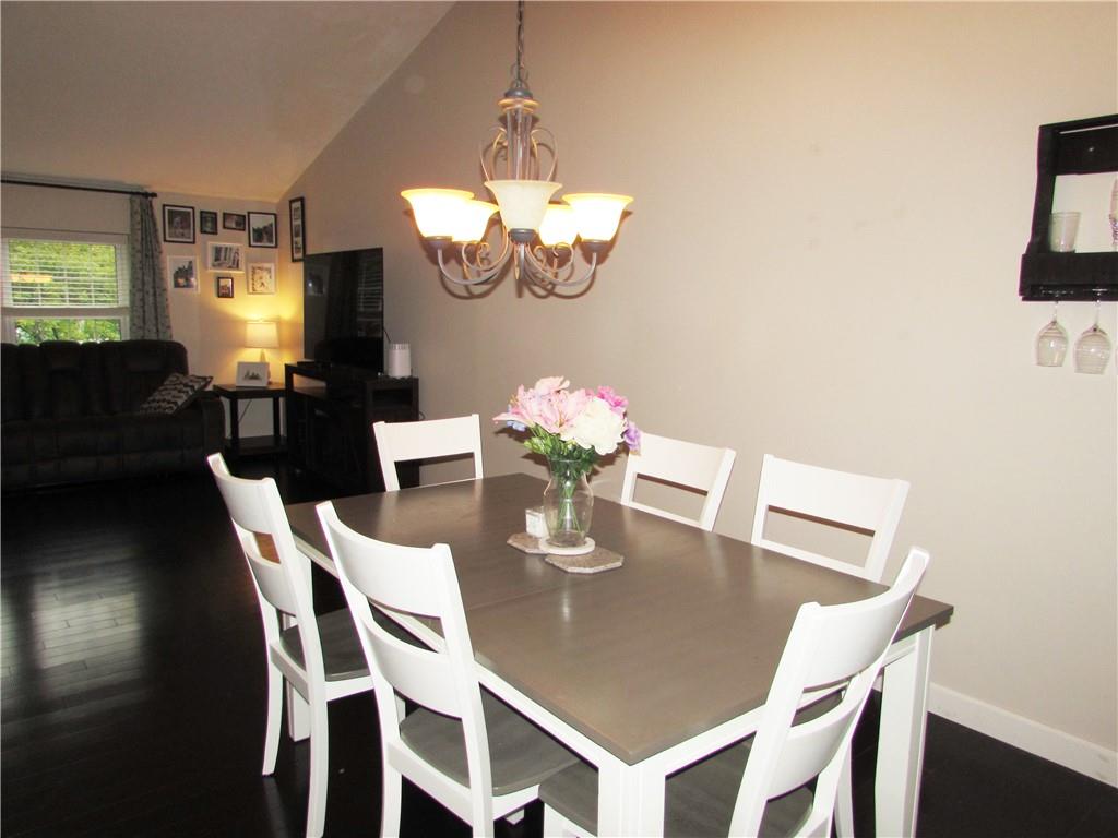 417 Rampart Boulevard New Kensington, PA 15068 - Photo 11 of 39 a view of a dining room with furniture a chandelier and wooden floor