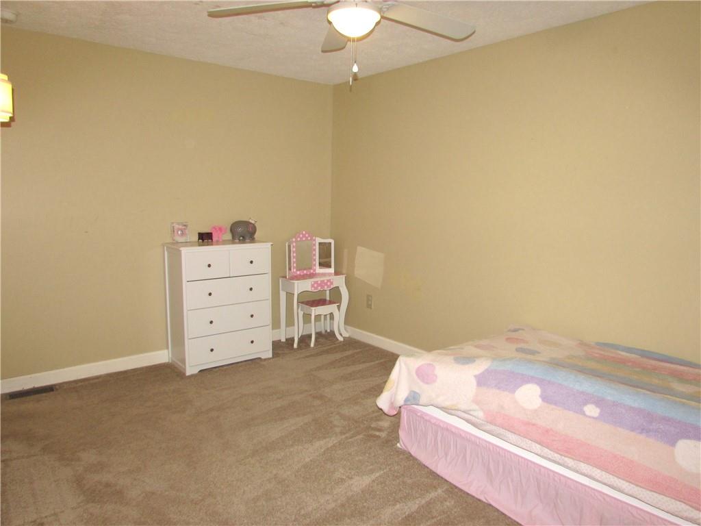 417 Rampart Boulevard New Kensington, PA 15068 - Photo 21 of 39 a bedroom with a bed and a chandelier