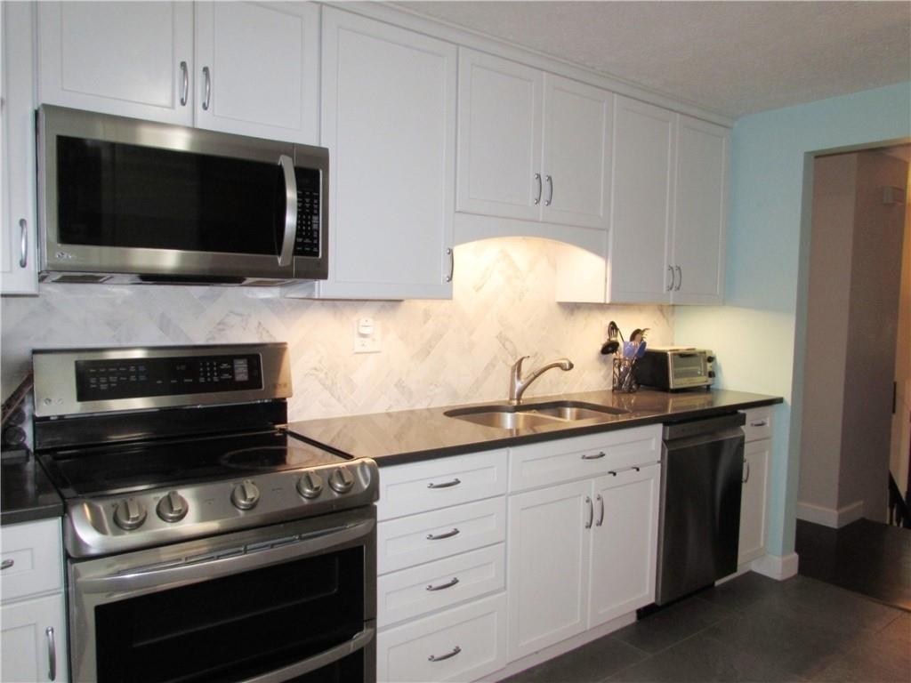 417 Rampart Boulevard New Kensington, PA 15068 - Photo 5 of 39 a kitchen with a stove and a microwave