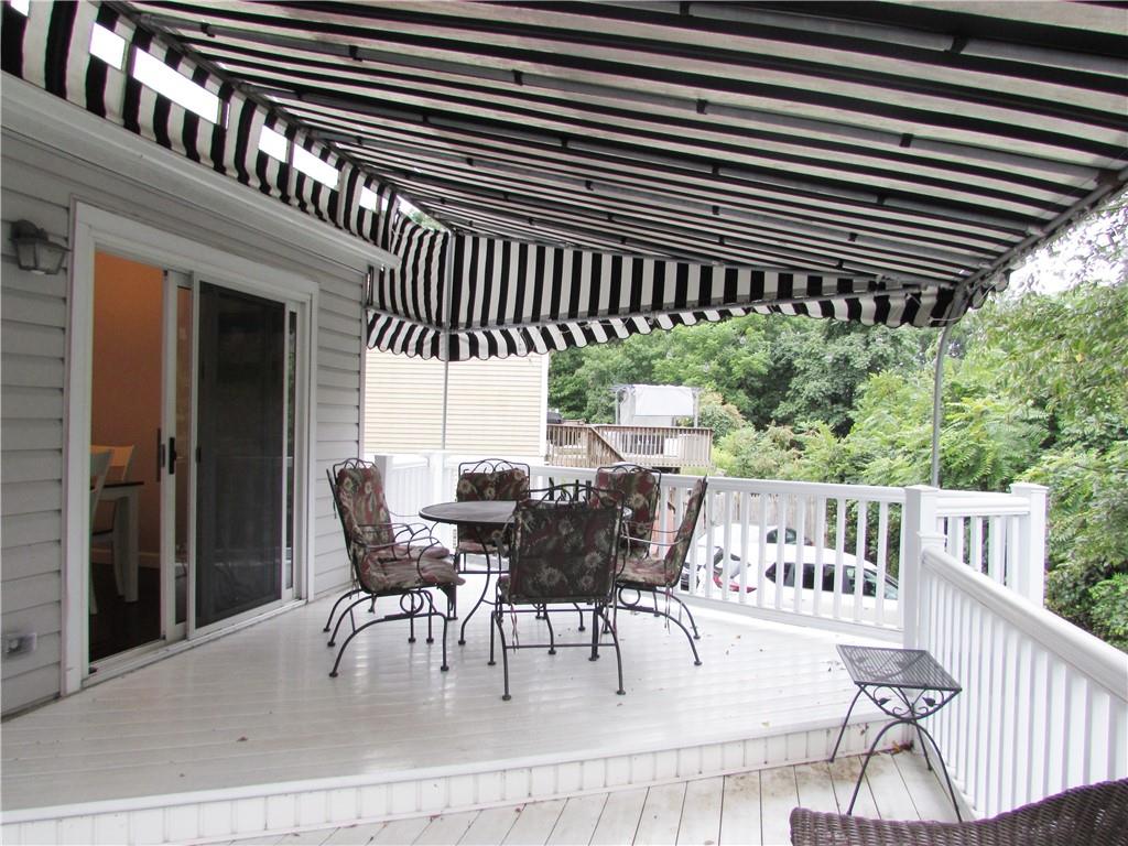 417 Rampart Boulevard New Kensington, PA 15068 - Photo 9 of 39 a view of a patio with table and chairs with wooden floor and fence and a yard