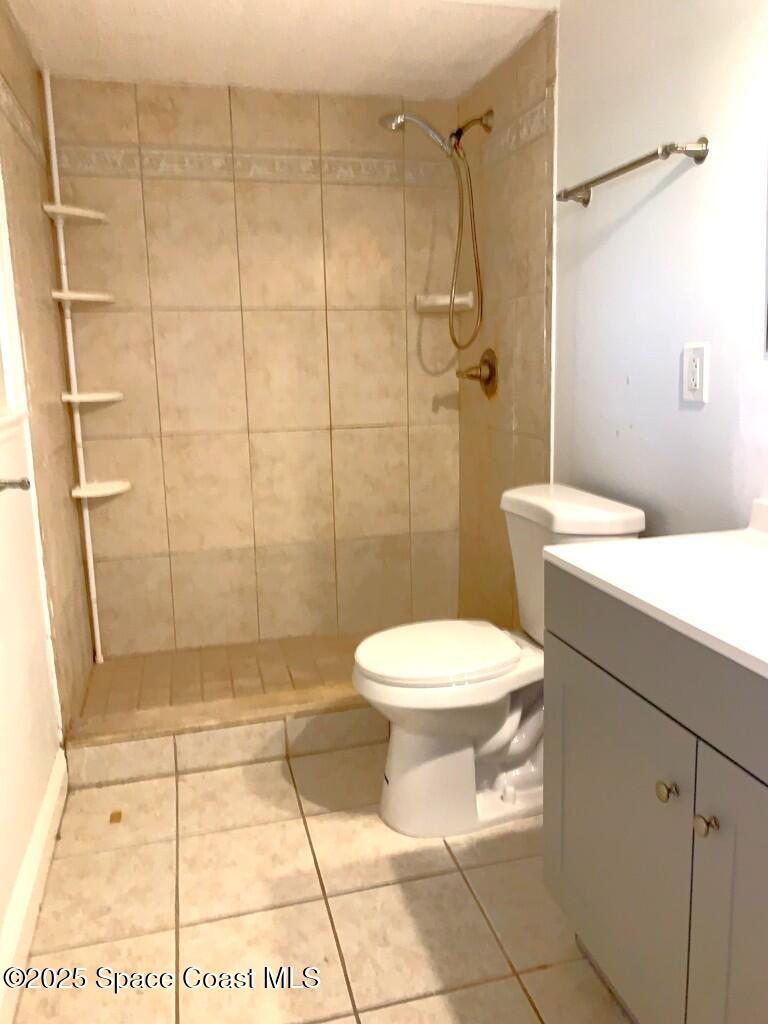 626 Fairhaven Street Northeast Palm Bay, FL 32907 - Photo 13 of 15 a bathroom with a toilet a sink and shower