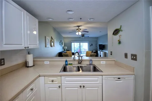 a view of a kitchen with cabinets stainless steel appliances and a counter top