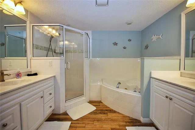 a bathroom with a tub sink and mirror