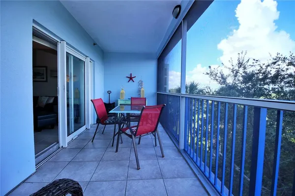 a view of a chairs and tables in the balcony