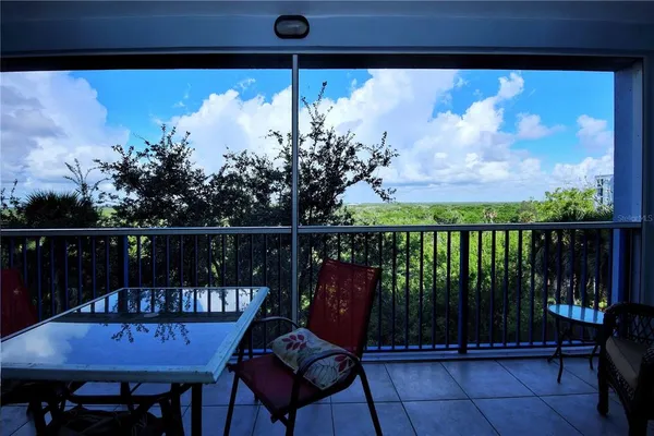 a view of a chairs and table in the balcony
