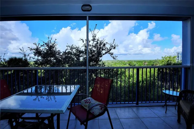 a view of a chairs and table in the balcony