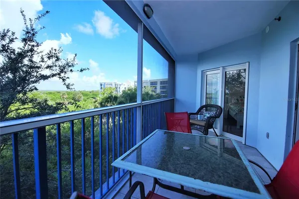 a view of a two chairs in the balcony